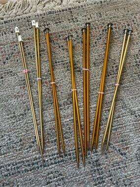 Knitting Needles in varying shades of gold and yellow